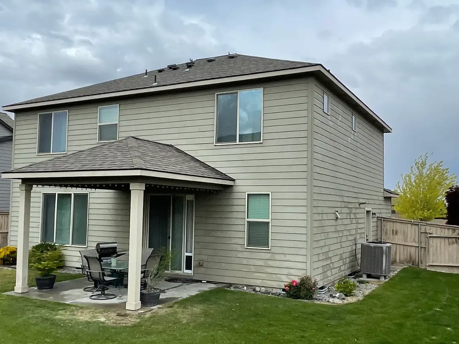 Before: the back of the home with tan siding