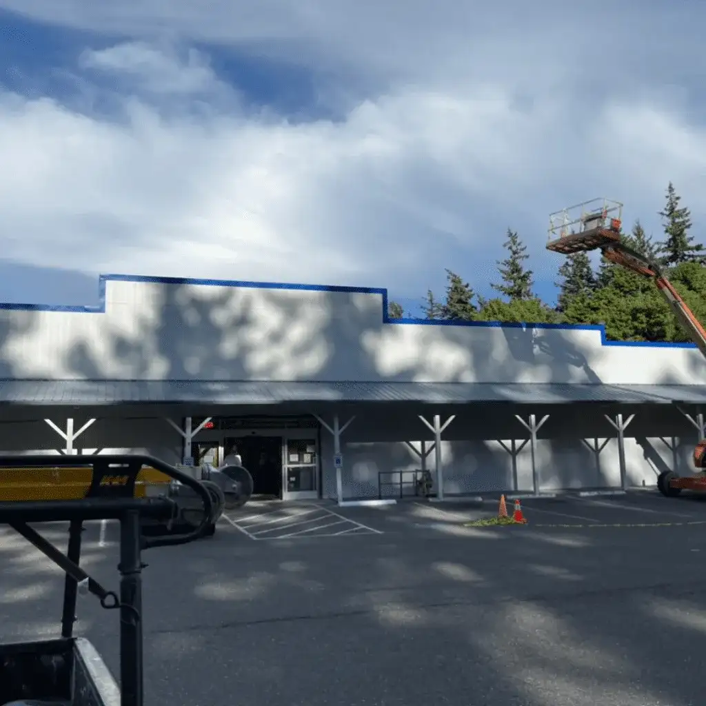 Commercial building with a boom lift set up along the roofline
