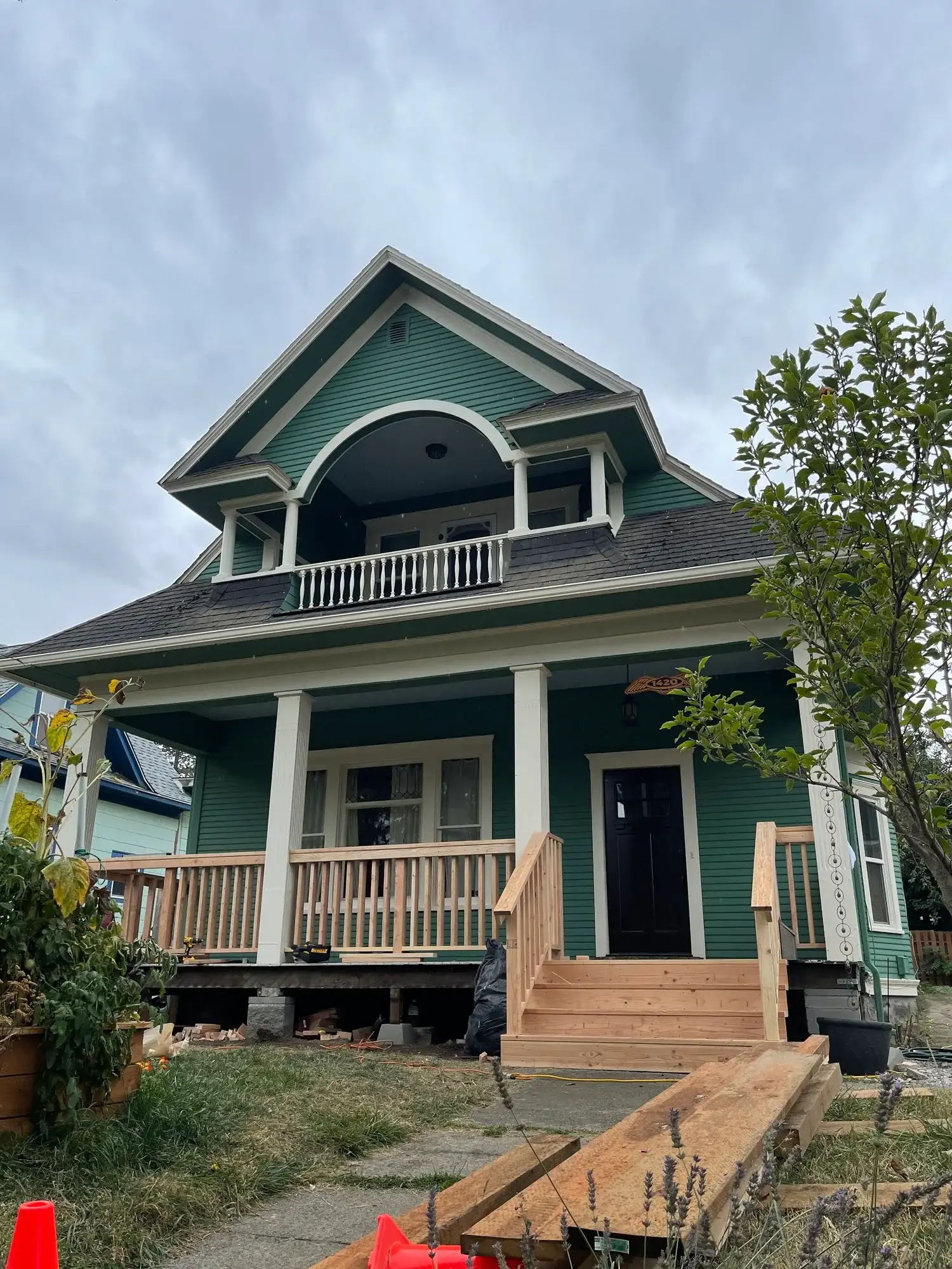Green Craftsman home from the street, with new porch stairs going in