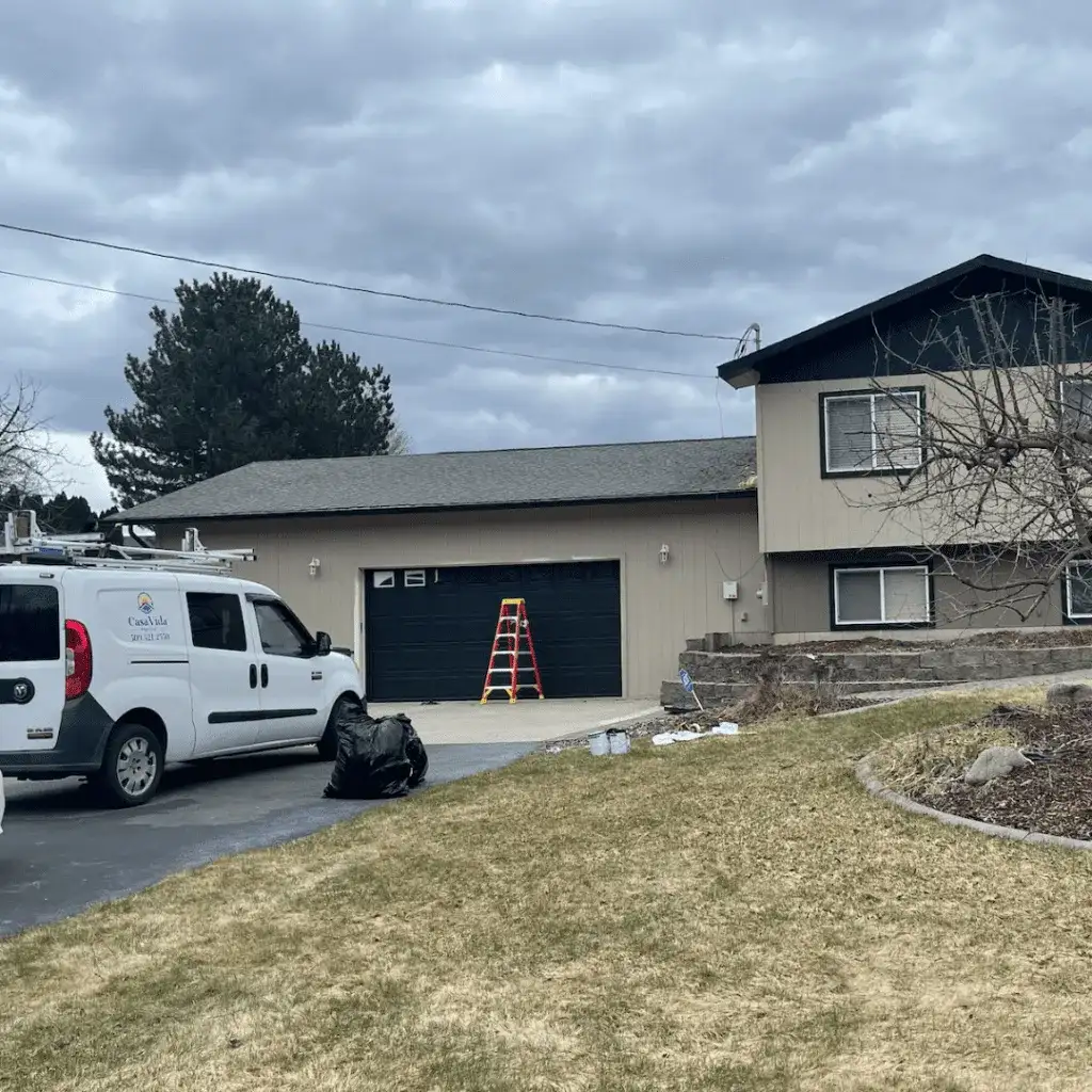 Casa Vida van, a ladder and a freshly painted garage door at a home